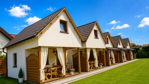 A row of single-story houses with pitched roofs and covered porches. - Holiday Homes for 5 People Near the sea (Kamien Pomorski)