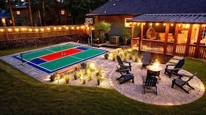 A basketball court with a fire pit and outdoor seating area. - Private Pickleball & Game Retreat with Fire Pit (Decatur)