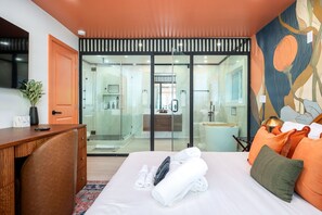 A hotel room with a bed, a desk, a bathroom with a glass door, and a large window. - Private Pickleball & Game Retreat with Fire Pit (Decatur)