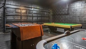 A room with a foosball table, pool table, and a foosball table with a brown cabinet. - 5 Bedrooms / 3.5 Bathrooms /Windsor Palms 8017 KP (Kissimmee)
