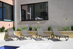A poolside area with lounge chairs and a large window overlooking the pool. - Ancora Adriatica (Kotor)