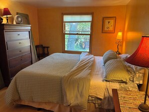 A bedroom with a bed, dresser, window, and lamp. - Urban Refuge in a welcoming East Bay  Neighborhood (Oakland)