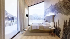 Un dormitorio con un ventanal grande, una cama, una mesita de noche y un mural en la pared con un paisaje montañoso.