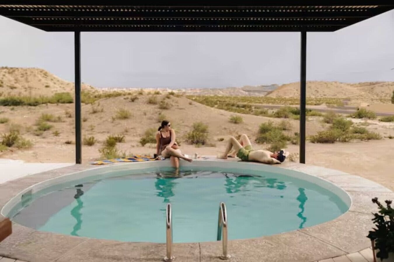 Une piscine avec deux personnes et un chien.
