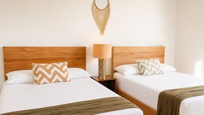 Two single beds with wooden headboards, white bedding, patterned pillows, a bedside lamp, and a macrame wall hanging. - 10 guests, amazing 3-bedroom apartment in downtown Playa del Carmen (Playa del Carmen)