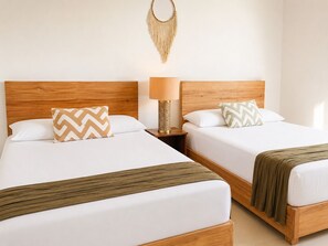 Two single beds with wooden headboards, white bedding, patterned pillows, a bedside lamp, and a macrame wall hanging. - 10 guests, amazing 3-bedroom apartment in downtown Playa del Carmen (Playa del Carmen)