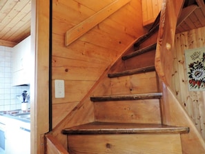 A wooden staircase with a handrail, leading to an upper floor. - Föhre, (Grächen), 1420 by Interhome (Grächen)