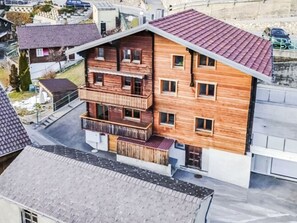 A multi-story wooden building with a balcony on the ground floor. - Charmant appartement dans chalet rénové by Interhome (Erschmatt)
