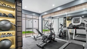 A modern gym with exercise equipment, a treadmill, and a wall-mounted rack with weights and medicine balls. - Anime apartment in Lima (Lima)