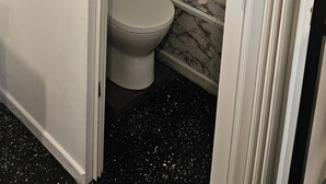 A bathroom with a toilet, a shower, and a marble floor. - Self contained rooms in a relaxing farm,  lots of views.
Pet-friendly (Illinbah)