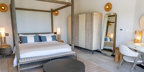 A bedroom with a four-poster bed, bedside tables, a mirror, a desk, and a chair. - Travel Better With a Stay Like This! 4BR Villa with Private Pool, Ocean Views! (Urlings)