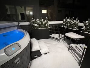 A hot tub area with a control panel, surrounded by snow-covered plants and seating. - Luxury 3 Bed Townhome • Walk to Town • on Ski Bus • Hot Tub • 2-Car Garage (Fraser)