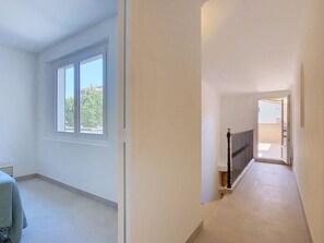 A hallway with a staircase leading to an outdoor area. - Maison Lou Oustaou by Interhome (Sainte Maxime)