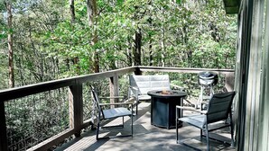 Une terrasse en bois avec des meubles d’extérieur et un barbecue.