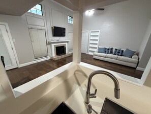 A modern kitchen with a stainless steel sink, a built-in oven, and a white countertop. - Big family friendly 13 minutes from AT&T stadium Peaceful 3bedroom covered patio (Arlington)