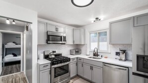 A modern kitchen with stainless steel appliances, a built-in oven, and a microwave.