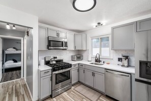 A modern kitchen with stainless steel appliances, a built-in oven, and a microwave.
