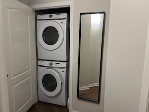 A laundry room with two stacked washing machines and a mirror on the wall. - Spacious 1bdrm apartment 10 mins to Cedars-Sinai by car FREE Parking, King bed (Los Angeles)