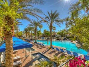 A resort pool area with lounge chairs and palm trees. - Luxury-Remodeled-Pools-Patios, Ground Floor-3 BD 2BA 12 Pools Jacuzzi Views (La Quinta)