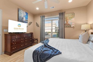 A hotel room with a bed, a television, a dresser, and artwork on the walls. - Smirnoff Pointe - Lakefront (Hollister)