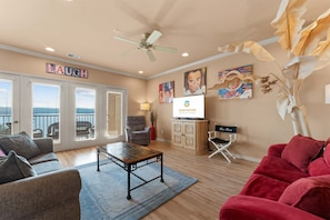 A living room with a sofa, armchair, coffee table, and artwork on the walls. - Smirnoff Pointe - Lakefront (Hollister)