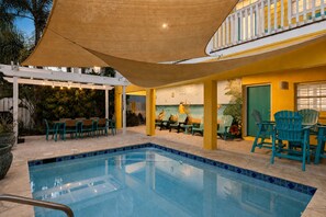 A swimming pool with chairs and a covered seating area. - Canary by the Sea | Sunny Beachside Escape • Private Pool • 2 Min Walk to Beach (South Padre Island)
