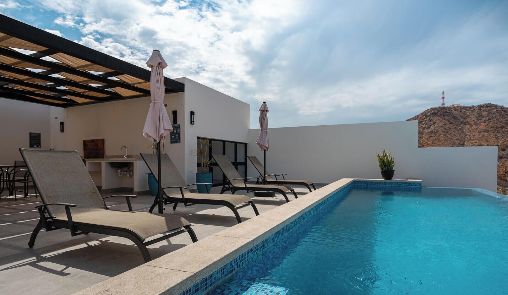 Outdoor pool, pool umbrellas, sun loungers