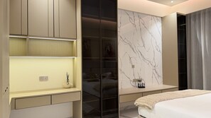 A modern bedroom with a bed, a bedside table, a mirror, and a wardrobe.