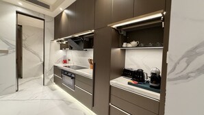 Een moderne keuken met ingebouwde apparatuur, een marmeren aanrechtblad en een strak design.