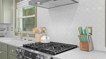 Coffee/tea maker, fridge, cookware/dishes/utensils