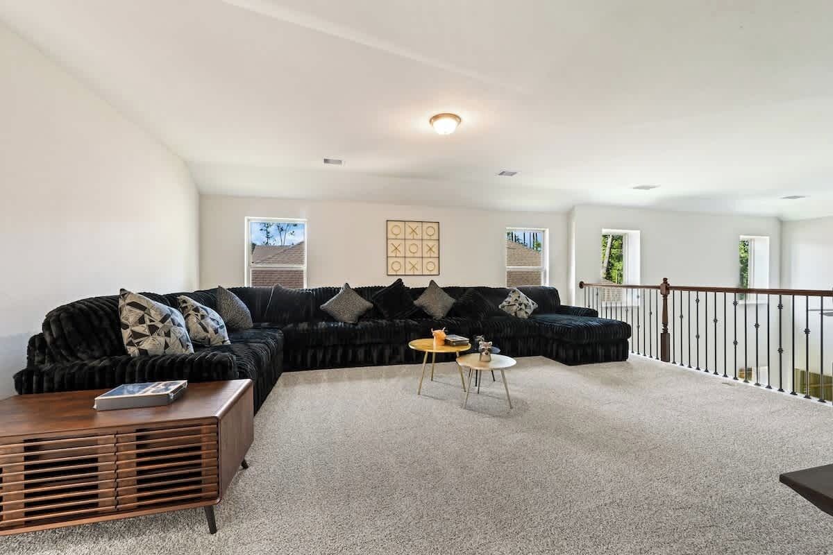 A living room with a sectional sofa, a coffee table, and a small side table.