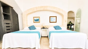 A hotel room with two beds, a nightstand, a mirror, and a view of the outside. - 7BR Villa with Private Pool & Spectacular Views (Acapulco de Juárez)