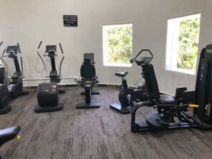 A gym with various exercise equipment, including treadmills, stationary bikes, and weight machines. - 7BR Villa with Private Pool & Spectacular Views (Acapulco de Juárez)