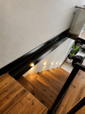 A wooden staircase with a black handrail and a white wall. - Piton View Pool Villa Near Attractions-Saba M1 (Soufrière)