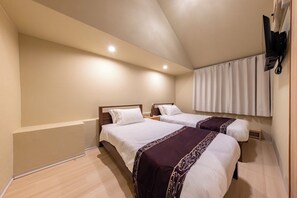 A hotel room with two beds, a flat-screen TV mounted on the wall, and a window with curtains. - Central Namba and Dotonbori | Spacious 7-bedroom, 1-living room, 1-dining room, 1-kitchen unit with a panoramic open-air bath and BBQ, accommodating up to 14 guests (大阪市)