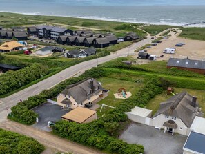 A coastal residential area with multiple houses, a main road, and a beach in the background. - "Algut" - 200m from the sea by Interhome (Blåvand)