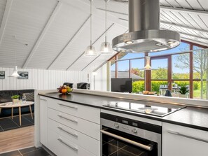 A modern kitchen with a large island, stainless steel appliances, and a view of the outdoors. - "Aida" - 550m from the sea by Interhome (Esbjerg V)