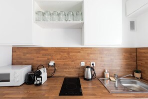 A kitchen with a microwave, toaster, kettle, and a sink. - Upstays Studio 28m2 Balcony AC (Cannes)