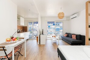 A modern apartment with a kitchen, dining area, and living room. - Upstays Studio 28m2 Balcony AC (Cannes)