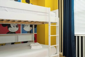 A bunk bed with a lower bunk, a desk, and a chair. - Cozy 3BR Apartment Storey Lake Resort Near Disney (Kissimmee)