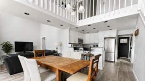 A modern kitchen with white cabinets, a microwave, and a refrigerator. - `Reflection`s Edge` Lake House & Private Dock! (Port Angeles)