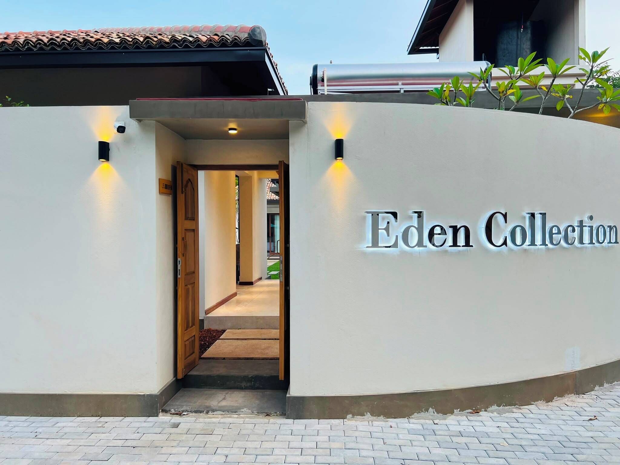L’entrée d’un immeuble, avec une enseigne indiquant « Eden Collection ».