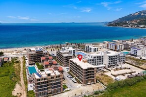 A coastal residential area with modern buildings, a swimming pool, and a view of the sea. - Palm Olive Studio, Vlore, Albania (Vlore)