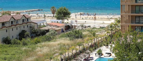 A resort with a pool, beach, and mountain views.