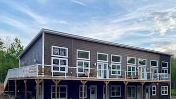 A two-story building with a balcony and multiple windows.