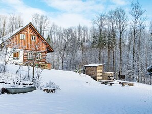 A log cabin with a wooden deck and a small wooden structure nearby. - U Kazíků by Interhome (Vysoké nad Jizerou)