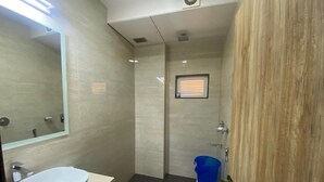 A bathroom with a sink, toilet, and a mirror.