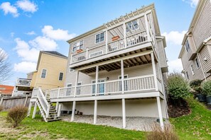 A two-story residential building with a balcony on the ground floor and a second-floor balcony.