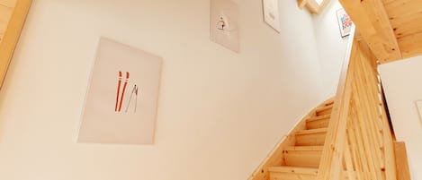 A wooden staircase with a view of the upper floor.