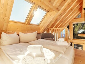A wooden interior with a bed, pillows, and a skylight. - Chalet Nr. 6 für 2 Personen mit Sauna by Interhome (Niederwölz)